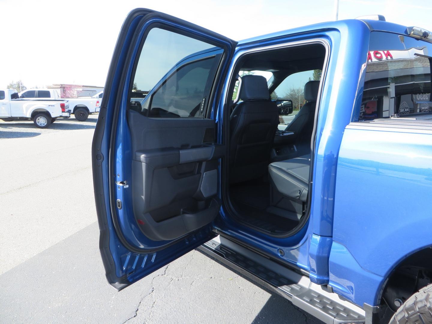 2022 BLUE /BLACK Ford F-150 Lariat Crew Cab 4WD (1FT6W1EV6NW) , located at 2630 Grass Valley Highway, Auburn, CA, 95603, (530) 508-5100, 38.937893, -121.095482 - Tired of gas prices and still want to look cool? Check out this Ford Lightning featuring a RC level kit, Nitto Ridge Grappler tires, Fuel Rebel wheels, Sinister front and rear bumpers, Baja Designs leds, Rigid Industries Leds, Bakflip F1, and window tint. - Photo#53